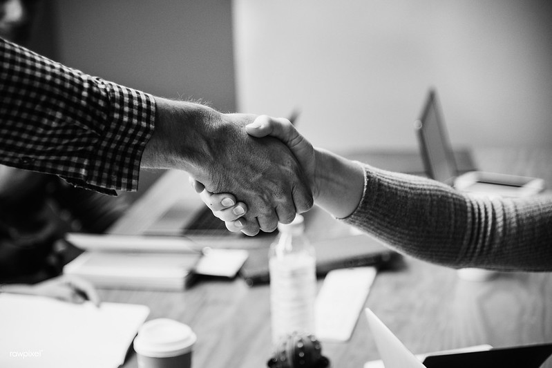 Handshake between business staff member and a client